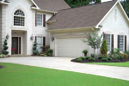 A spacious white house with a garage door